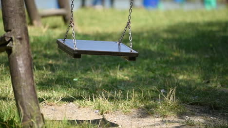 Empty-swing-on-playground-in-park
