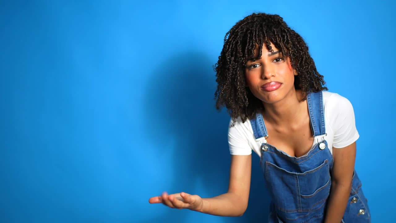 Woman in overalls on a blue background