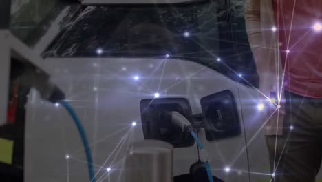 Man-charging-an-electric-car-with-network-of-connections-moving