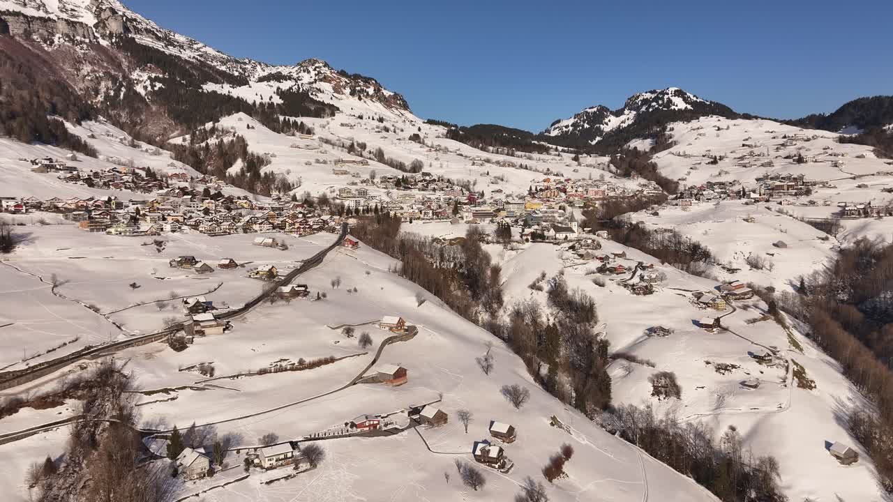 Beautiful aerial view of Amden, Switzerland covered in snow, scenic Swiss alps, charming village and breathtaking winter landscapes.