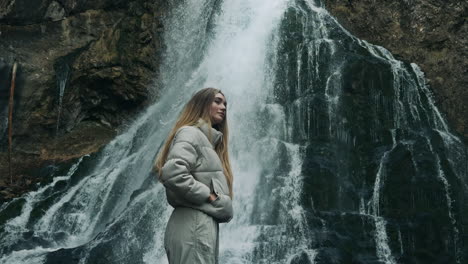 woman by a waterfall