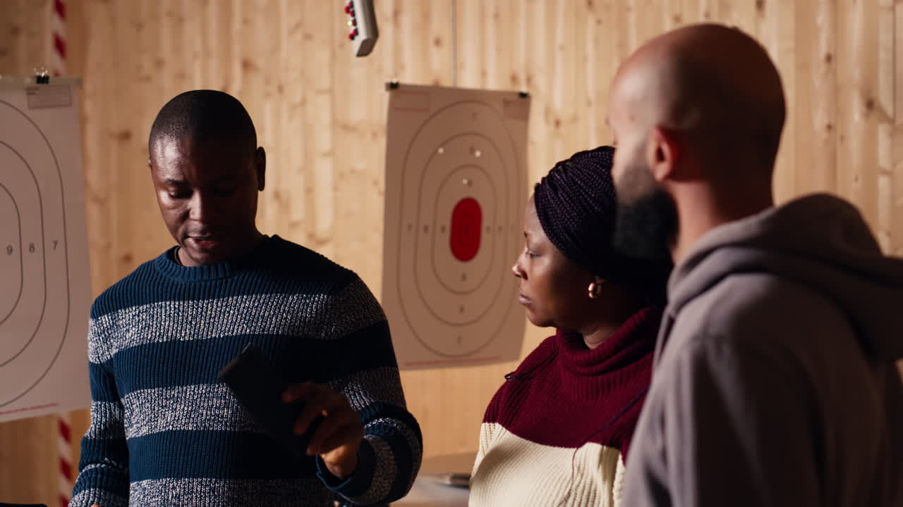 Shooting range safety officer demonstrating how to safely reload rifle