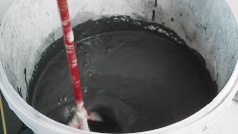 black wall paint mixing paint bucket