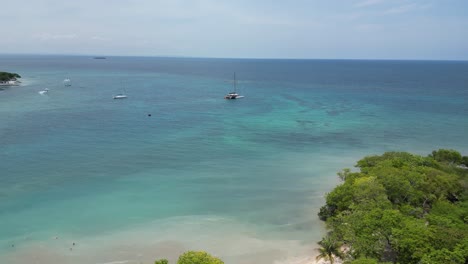 Beautiful-drone-shot-over-an-exotic-private-island-and-catamaran