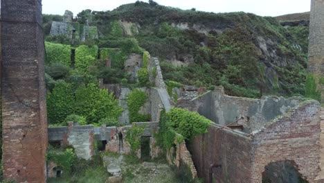 Porth-Wen-Vista-Inversa-Aérea-Abandonada-Fábrica-De-Ladrillos-Industriales-Victorianos-Permanece-En-La-Costa-Erosionada-De-Anglesey