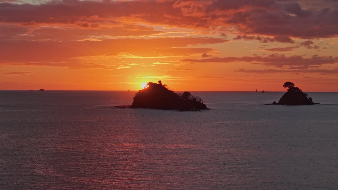 Vibrant orange sunset over Las Catalinas islands in the Pacific Ocean, Costa Rica