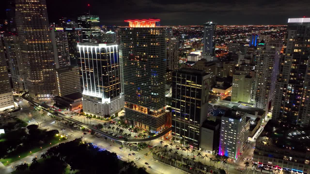 Nighttime magic in Miami, showcasing the city's skyline with landmark buildings and active traffic