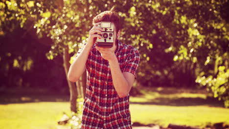 in high quality 4k format handsome hipster with retro camera