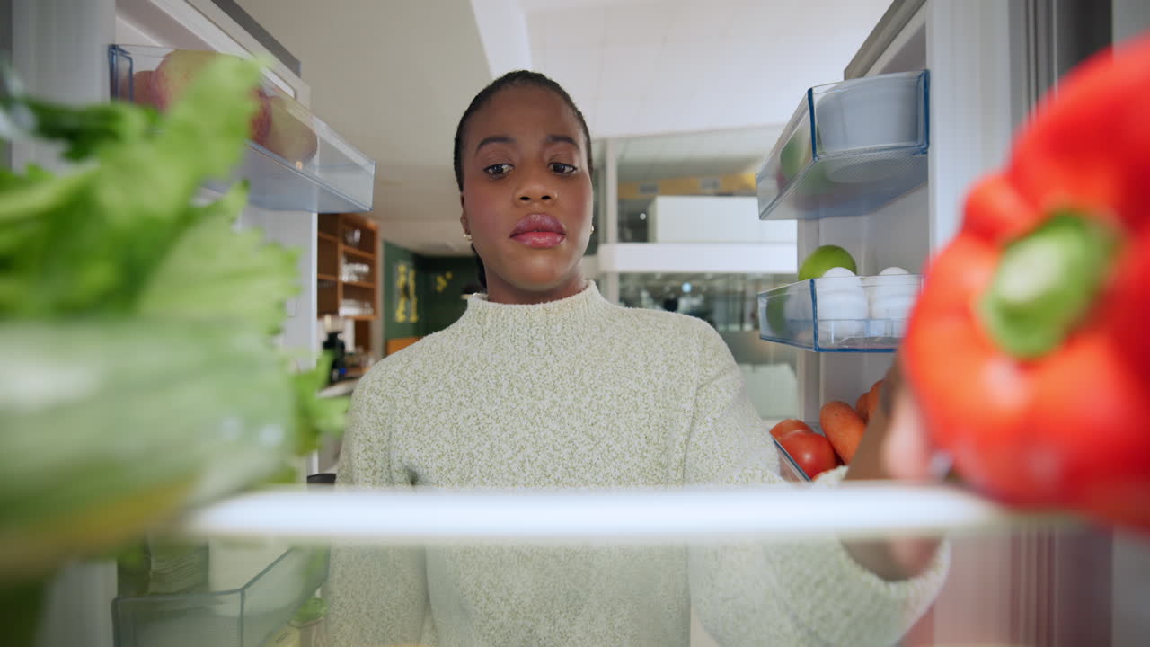 Woman Looking at Food in Refrigerator