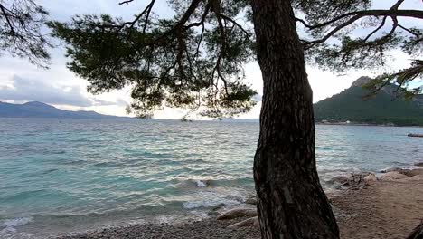 small pebble stone beach, mallorca, spain, secluded mediterranean sea