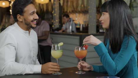 tracking shot of man and woman talking in a bar