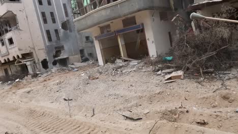 perspective of an idf army jeep passing through the gaza strip, you can see buildings and houses completely destroyed by israeli missile attacks