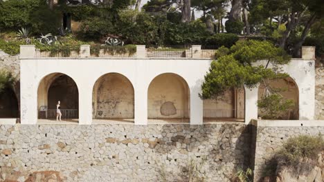 classy girl walking through the passage of the hacienda in amazing costa brava beauties