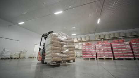 warehousing. forklift driver stacking big bag of raw material in warehouse.