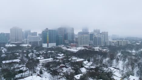 rotating aerial shot around snow covered midtown buildings in atlanta georgia on january 10th 2025.