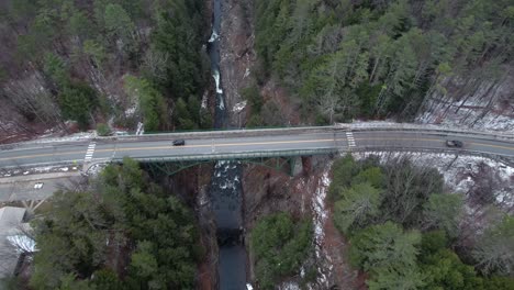 ottauquechee river gorge, rising aerial in quechee vermont, cars drive over bridge