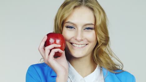 portrait of an attractive young woman with red apple hd video