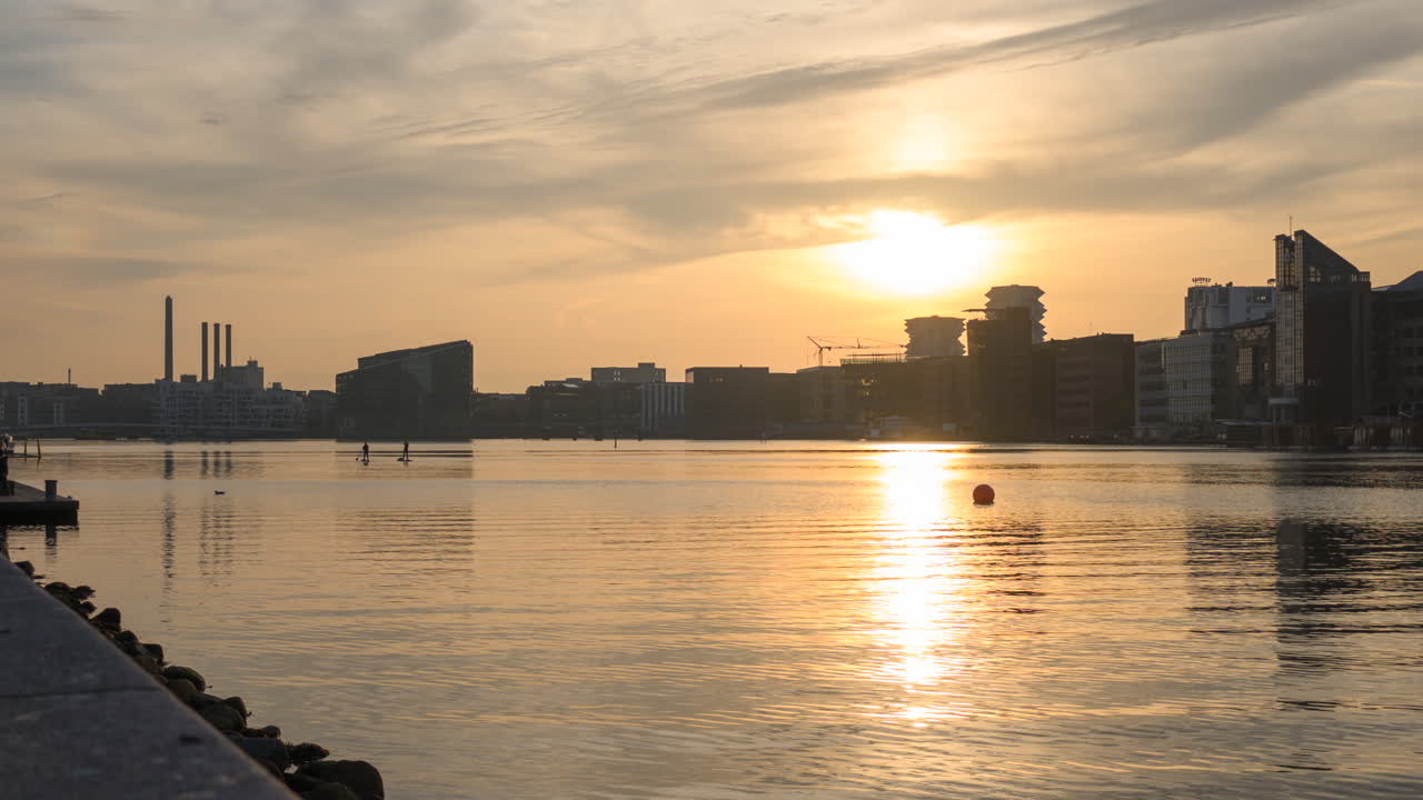 Sunset timelapse from Islands Brygge south harbour with moving boats and sup surfers