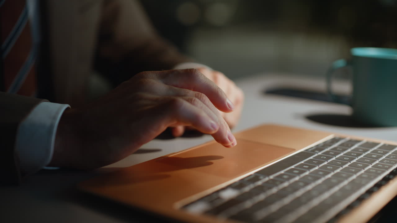 Night man finger swiping laptop at workplace closeup. Freelancer working late