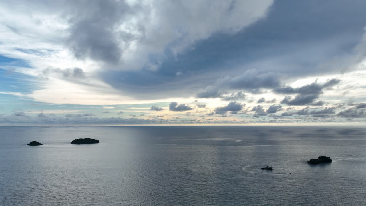 Timelapse showing clouds drifting over the calm ocean near Koh Chang, Thailand, capturing shifting light, tranquil seascapes, and the peaceful tropical atmosphere