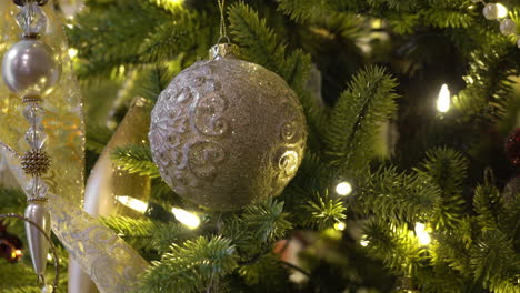 close up of beautiful cream ornaments adorning a christmas tree