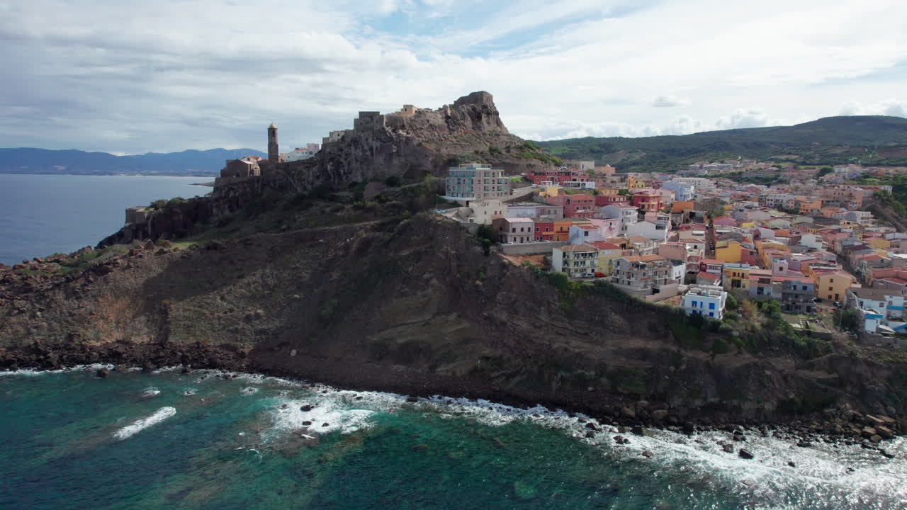 city of Castelsardo, Certe&ntilde;a: aerial view in orbit over this impressive city built on a mountain and with its colorful houses and its historic tower