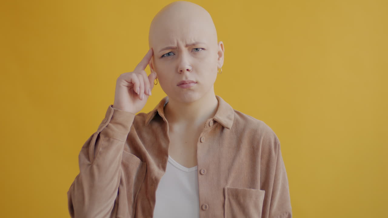 Woman with bald head thinking