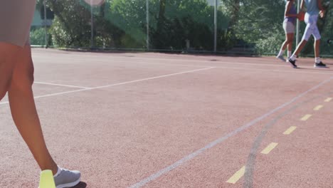 happy diverse female basketball team training on sunny court, in slow motion