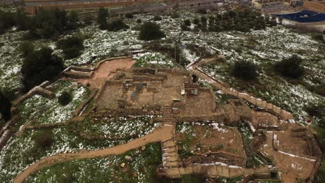 aerial view of ancient ruins covered in snow