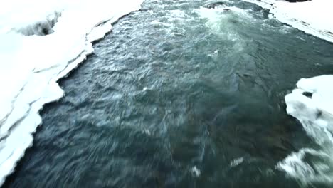 a stunning video captured by a high-quality drone shows fast-moving water flowing amidst glaciers from an aerial perspective, creating cinematic scenes