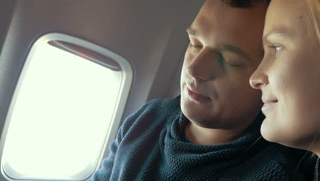 sleepy man and his girlfriend in the plane