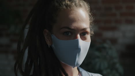 woman with dreadlocks wearing a face mask