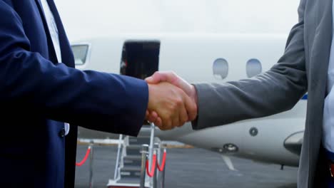 business people shaking hands with each other at terminal 4k