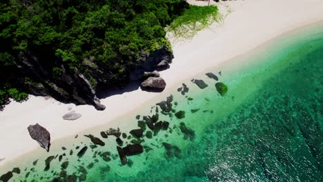 Drone-shot-of-a-beach-with-rock-formation-by-the-edge-of-the-cliff