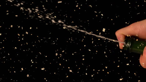 animation of confetti over man opening champagne on black background