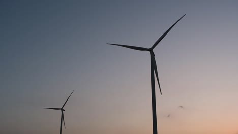 Wind-Turbines-Silhouette-against-the-Blue-sky-during-Sunset,-clean-alternative-energy-in-Thailand-and-mainland-Southeast-Asia