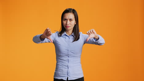 Filipino-girl-does-thumbs-down-sign-on-camera