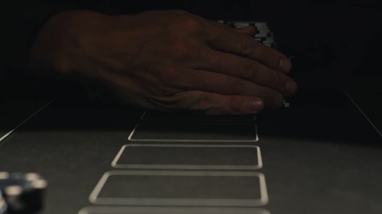 Hands managing poker chips on green table, reflecting intense poker gameplay with the element of chance and skill