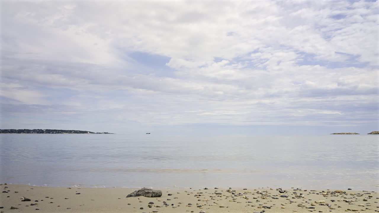 Time lapse of waves hitting the shore in Cannes, France on a cloudy day