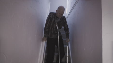 senior man using crutches on stairs