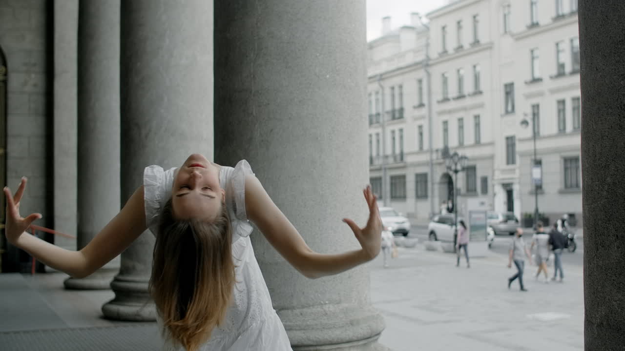 Woman Posing in Front of City Columns