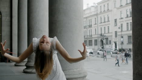 woman posing in front of city columns
