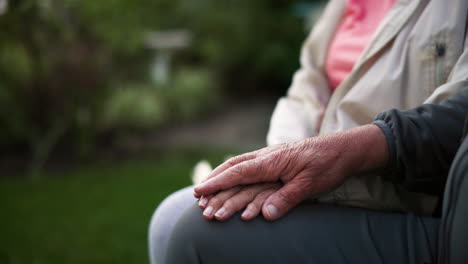 close-up of elderly couple holding hands