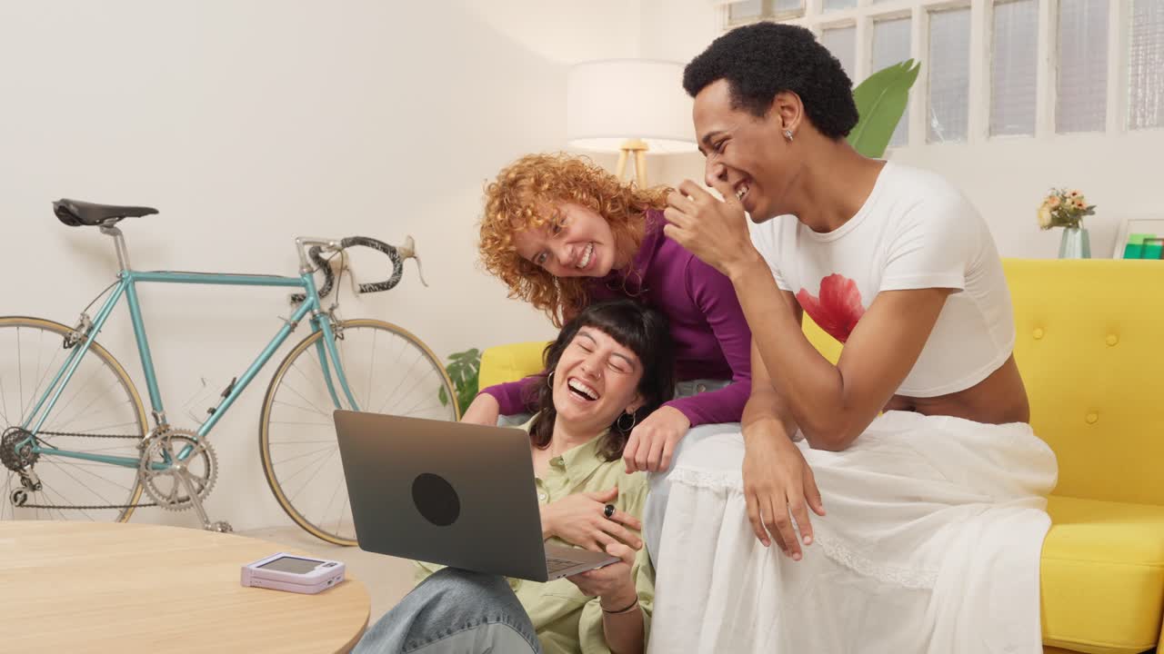 Friends using a laptop at home