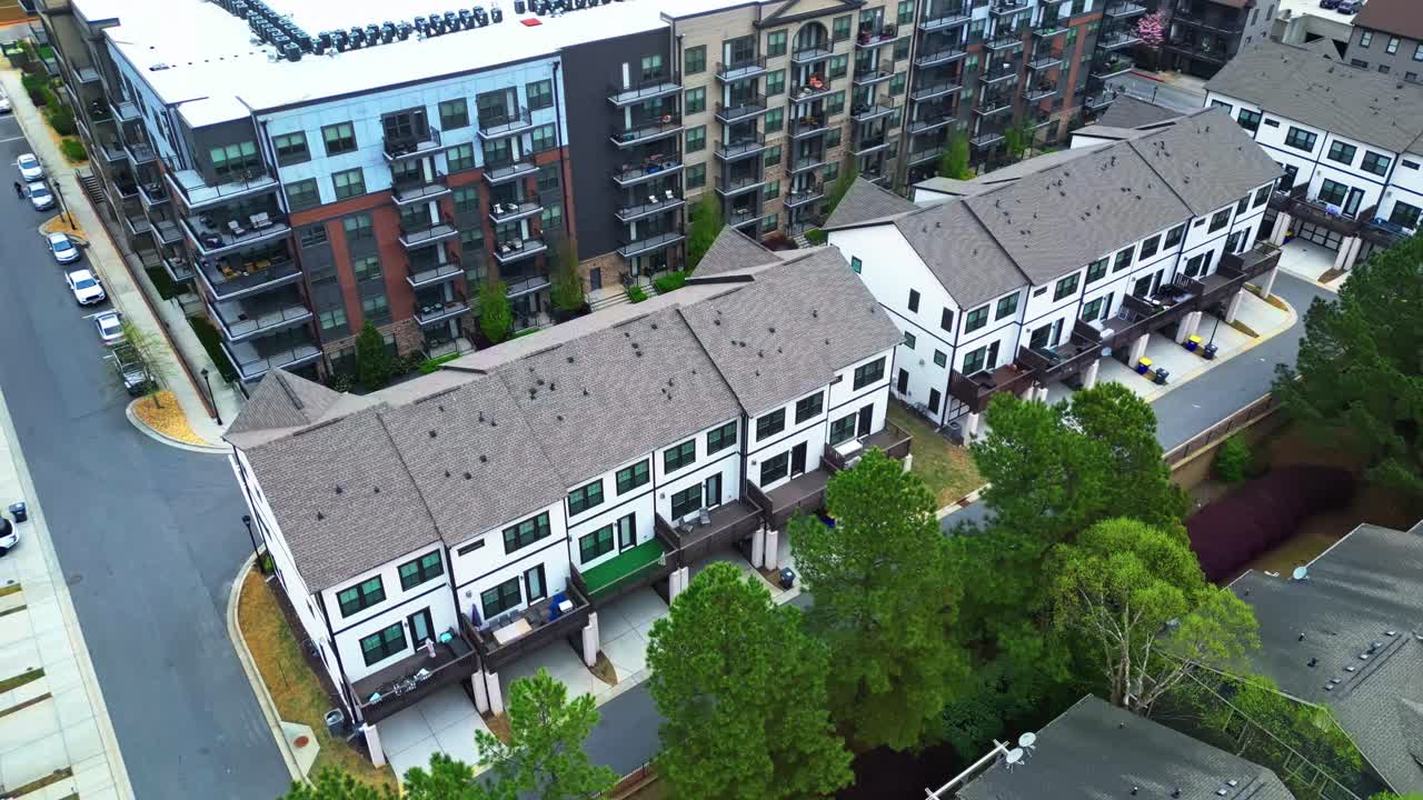 Two-story townhouse and residential Apartment block with balcony in American city. Aerial top down shot. Sunny day in springtime. Luxury houses and homes.