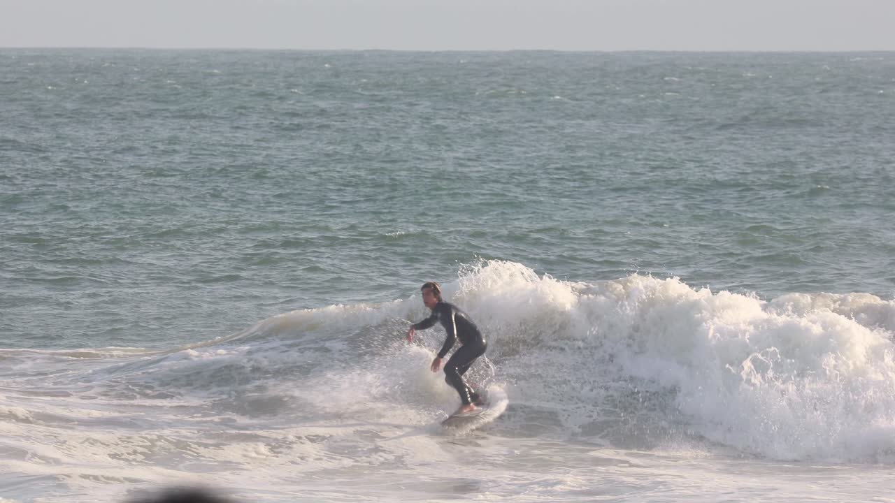 Fun roundhouse at the junction in a good surfing day, Carcavelos, Cascais