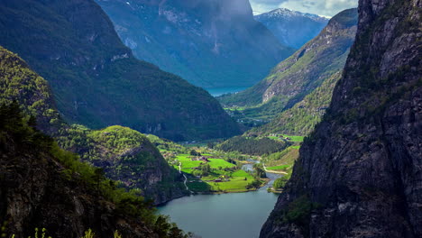 Idyllic-small-village-between-green-mountains-and-flying-clouds-during-sunny-day---Flam,Norway-at-Norwegian-Fjord---Time-lapse-shot