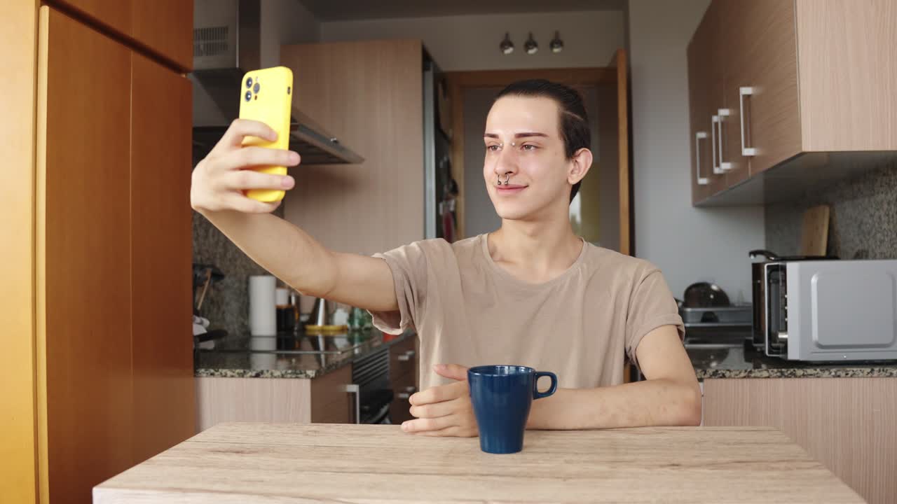 A man taking a selfie in his kitchen