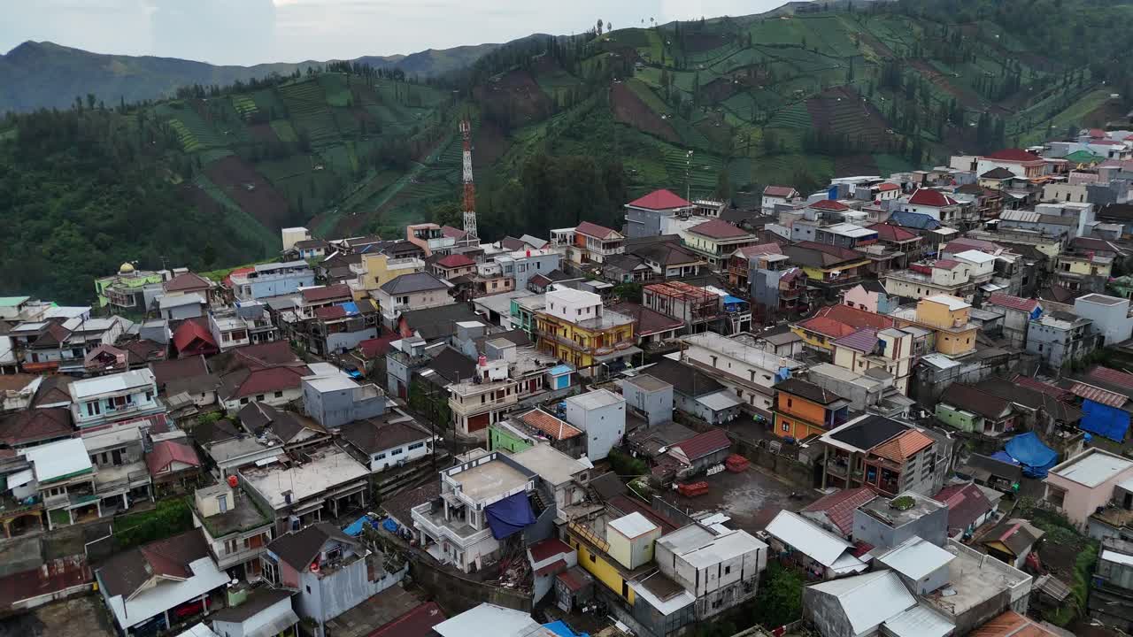 Aerial drone view of a small village town city in the rural hills mountains of east java indonesia