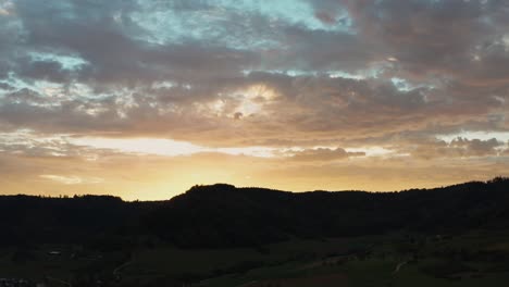 Erstaunlicher-Sonnenuntergang-über-Der-Bergsilhouette-Aus-Der-Luft